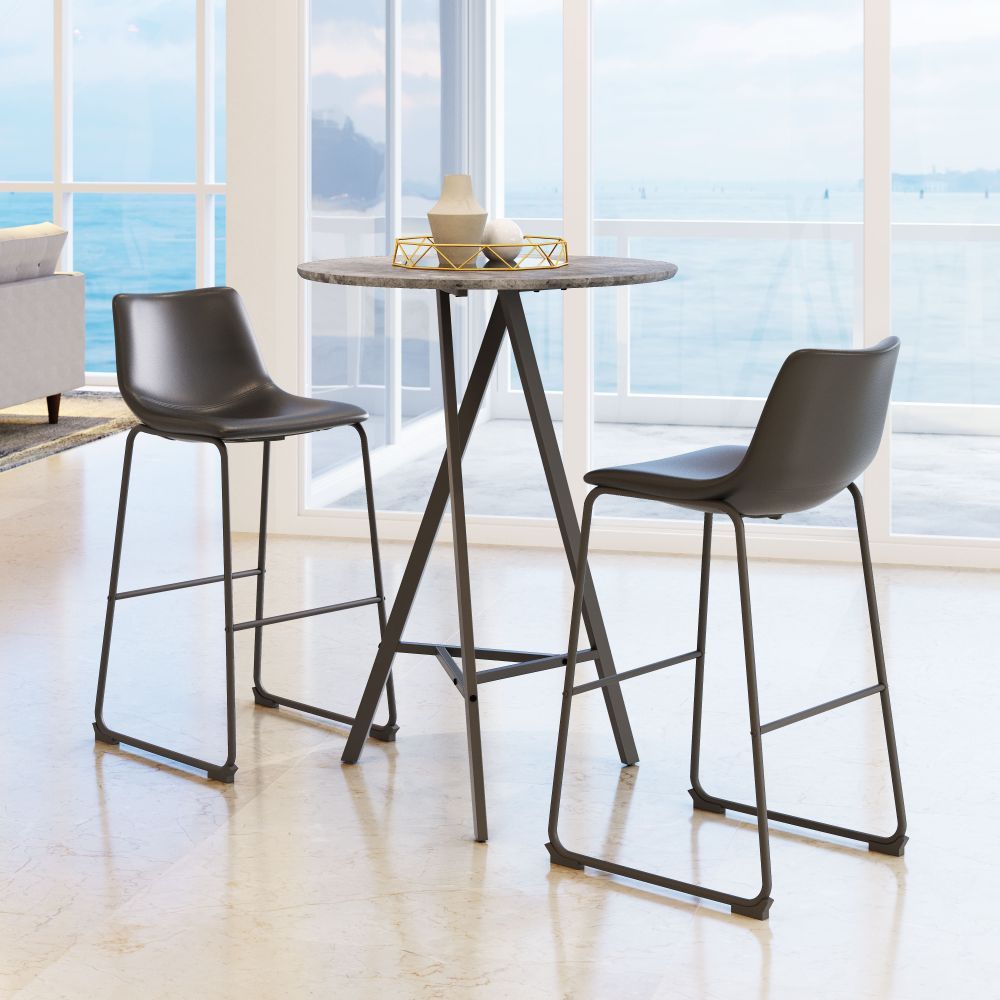 Two dark-colored bar stools with metal legs are placed around a round wooden table in a room with large windows.