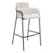Bar stool with beige cushioned seat and backrest on a white background