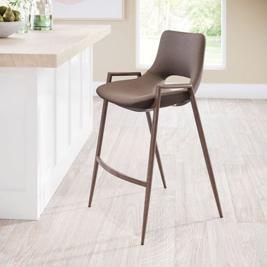 Brown bar stool in a modern kitchen setting with a white island and window in the background.