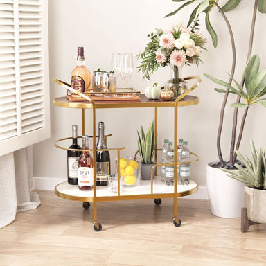 Gold bar cart with drinks and decor in a home setting