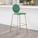 Green bar stool with gold legs in a kitchen setting