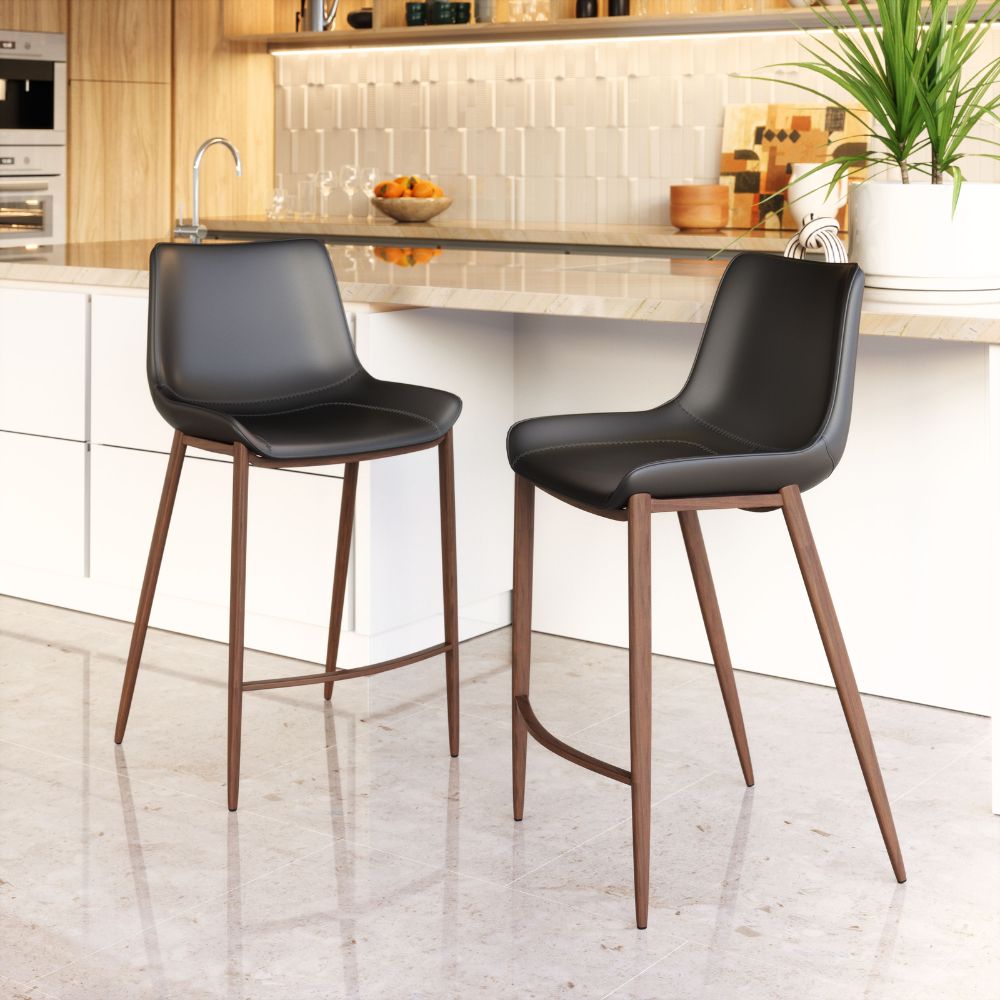 Two black bar stools with wooden legs in a kitchen setting.