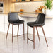 Two black bar stools with wooden legs in a kitchen setting.