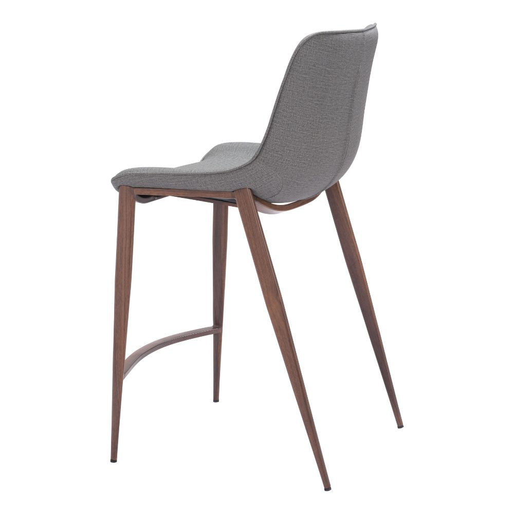 Bar stool with gray cushioned seat and wooden legs on a white background