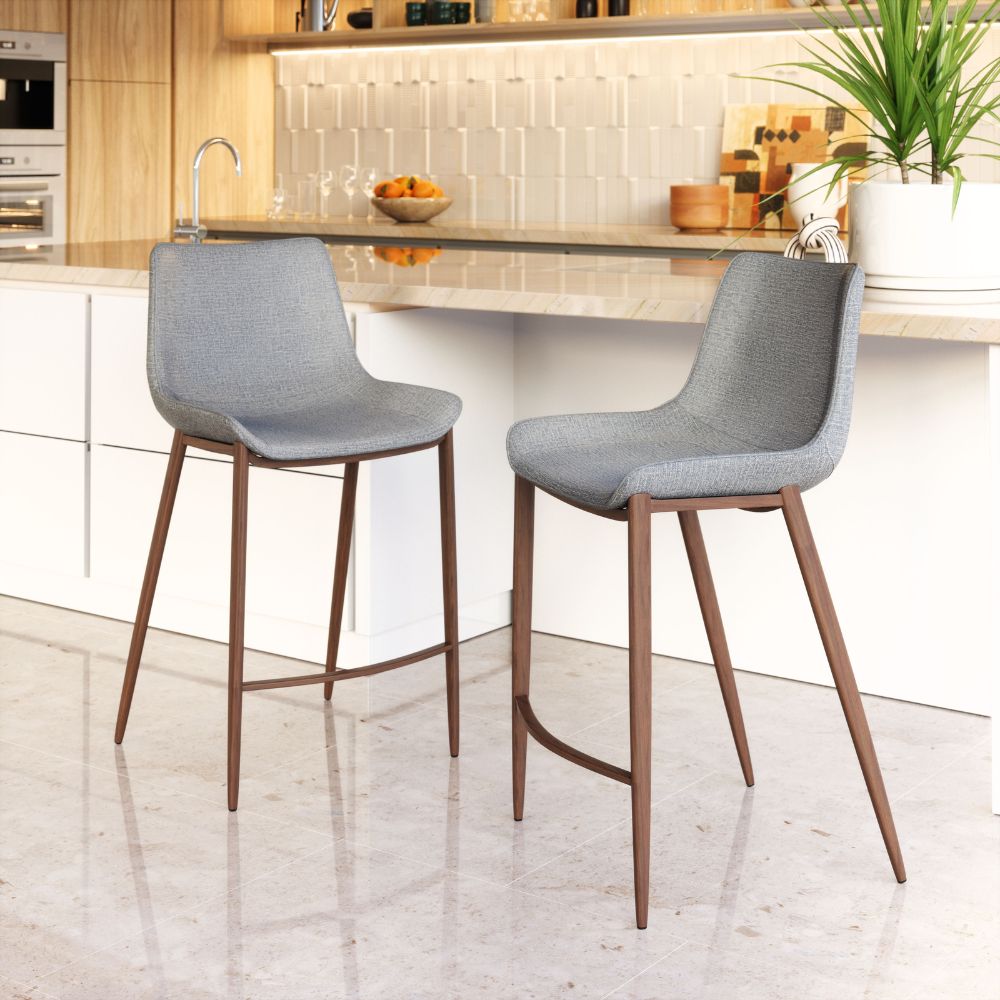 Two gray bar stools with wooden legs in a kitchen setting.