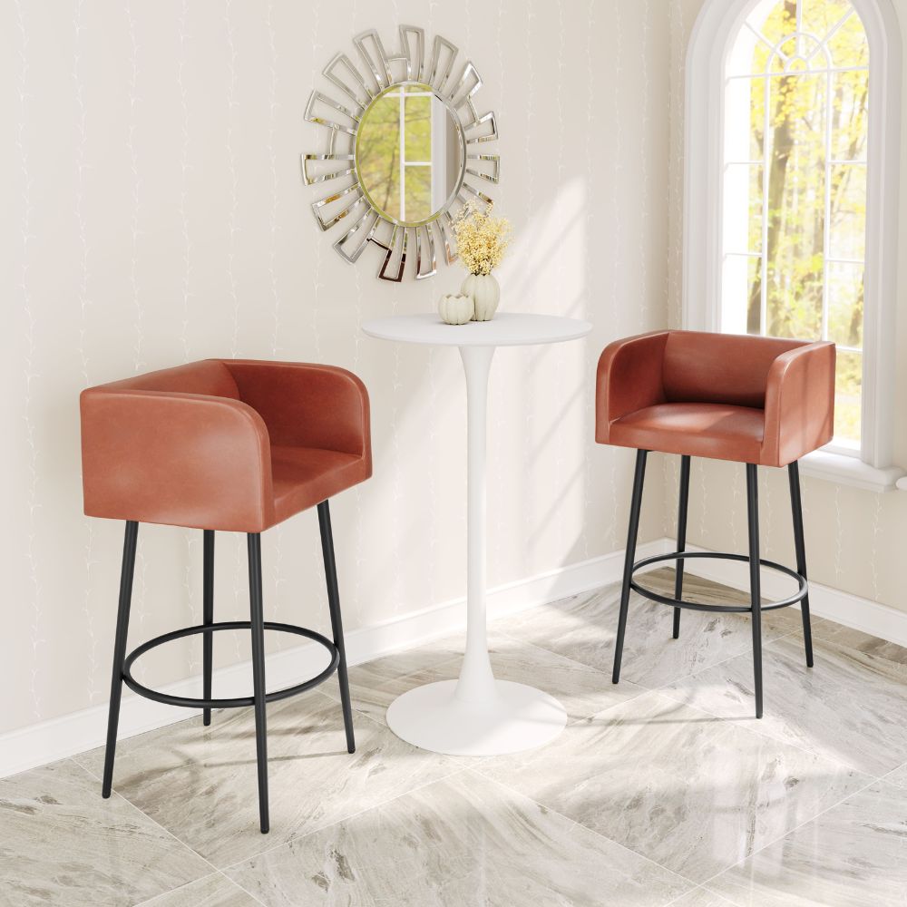 Two brown bar stools with black legs in front of a white table in a room with a decorative mirror.