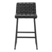 Black bar stool with tufted seat on a white background