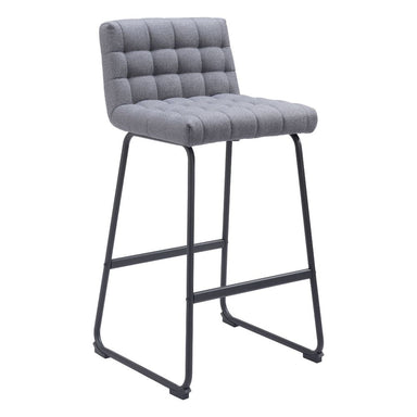 Gray bar stool with tufted seat on a white background