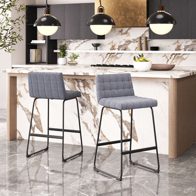 Two gray bar stools in a modern kitchen with marble countertops and pendant lights.