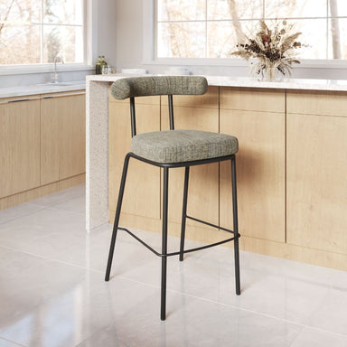 Bar stool with a cushioned seat and backrest in a kitchen setting.