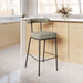Bar stool with a cushioned seat and backrest in a kitchen setting.