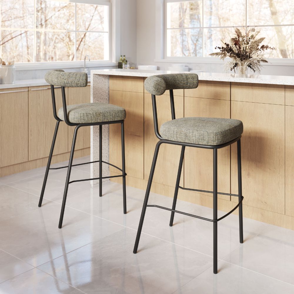 Two bar stools with cushioned seats in a kitchen setting.