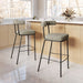 Two bar stools with cushioned seats in a kitchen setting.