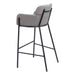 Gray cushioned bar stool with black metal legs on a white background