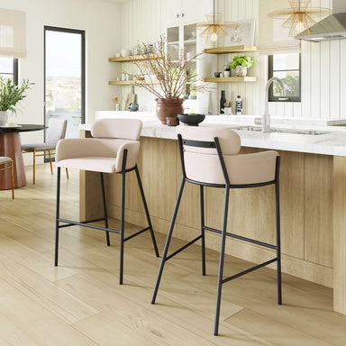 Modern kitchen with bar stools and a light wood floor