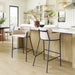 Modern kitchen with bar stools and a light wood floor