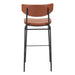 Bar stool with brown leather seat and backrest on a white background