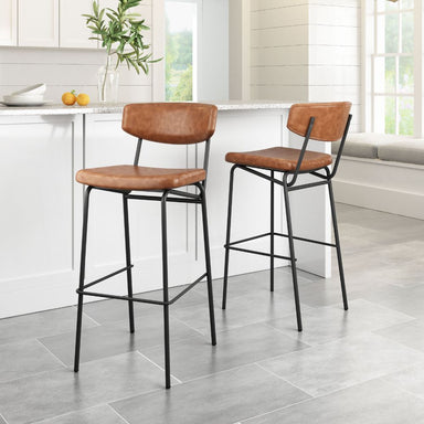Two brown bar stools with black metal legs in a kitchen setting.