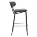 Bar stool with black metal frame and gray cushioned seat on a white background