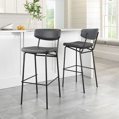 Two gray bar stools with black metal legs in a kitchen setting.
