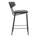 Bar stool with black metal frame and gray cushioned seat on a white background