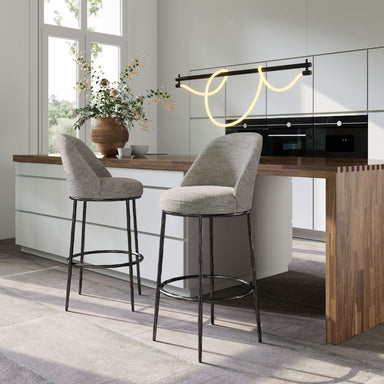 Modern kitchen with two gray bar stools and a wooden countertop.