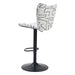 Bar stool with black and white patterned seat on a white background