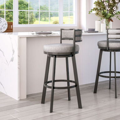 Bar stools with gray cushioned seats in a kitchen setting