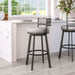 Bar stools with gray cushioned seats in a kitchen setting