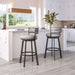 Two gray bar stools with black metal legs in a kitchen setting.