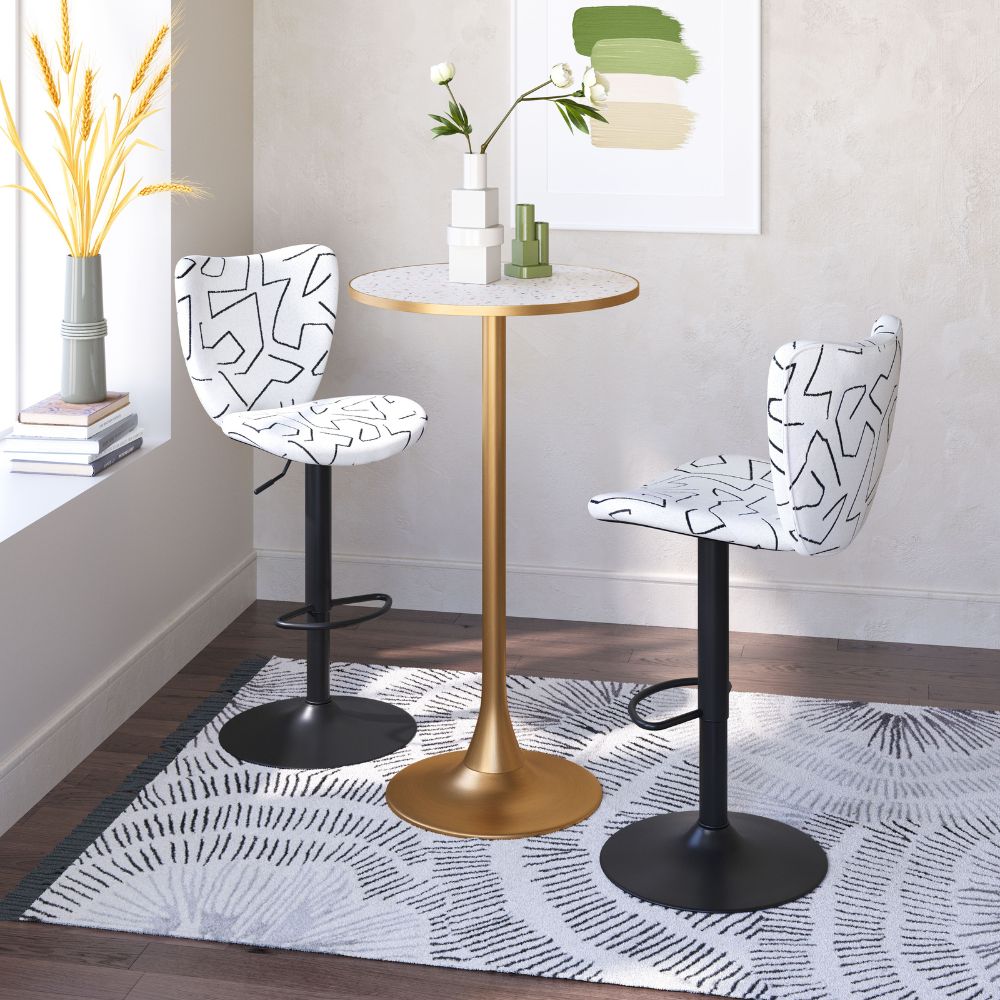 Two patterned bar stools with a gold table in a room setting.
