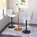 Two patterned bar stools with a gold table in a room setting.