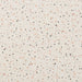 Terrazzo pattern with small specks of pink, black, and gray on a light beige background