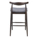 Bar stool with wooden frame and gray cushioned seat on a white background