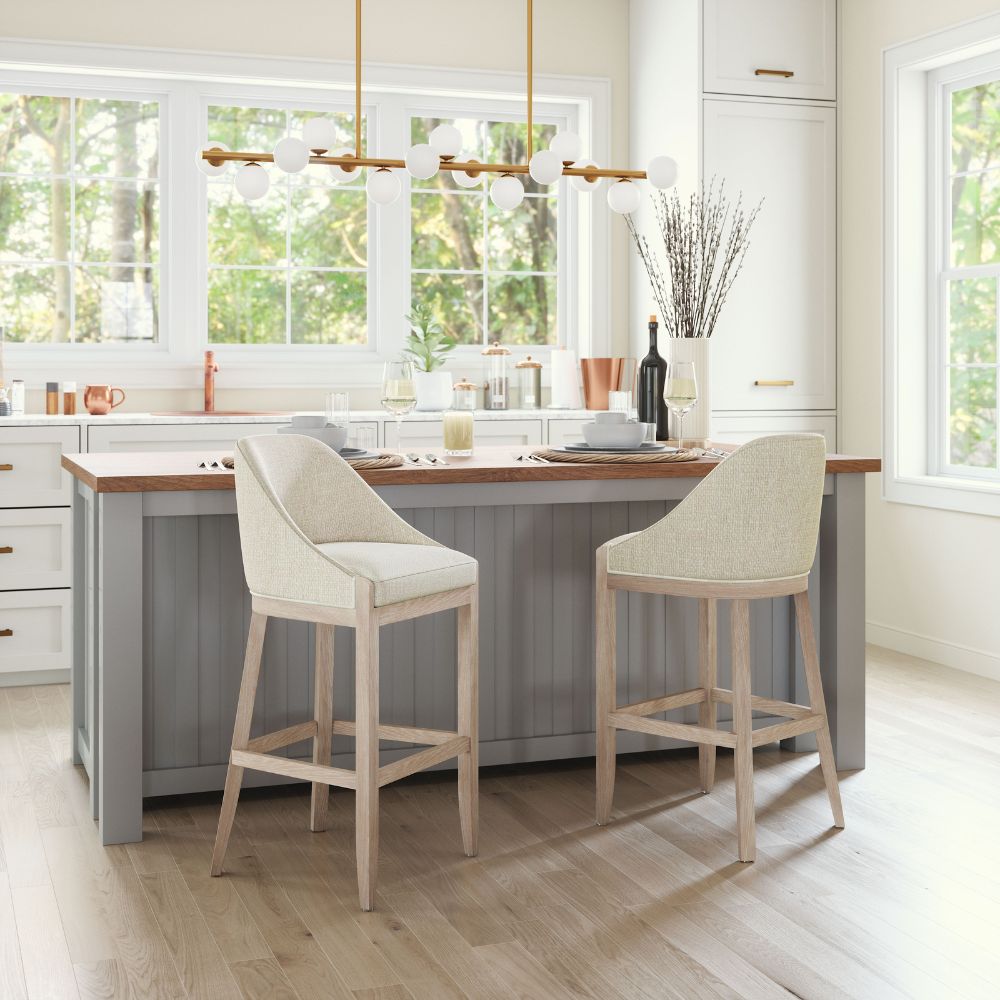 Modern kitchen with a island and bar stools in a bright room.