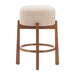 Beige cushioned stool with wooden legs on a white background