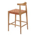Wooden bar stool with woven seat on a white background