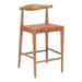 Wooden bar stool with woven seat on a white background