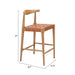 Wooden bar stool with woven seat and dimensions on a white background