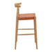 Wooden bar stool with woven seat on a white background