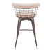 Bar stool with wire basket backrest and beige cushion on a white background