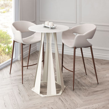White round table with two chairs on a wooden floor in a room with large windows.
