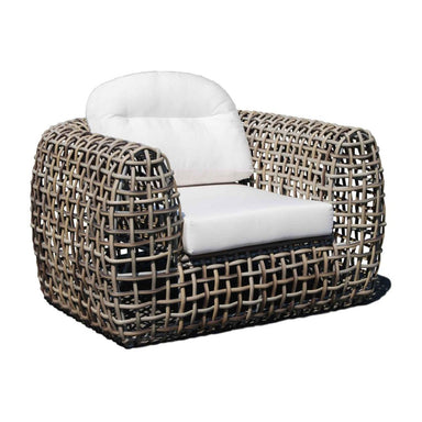 Woven chair with white cushions on a white background