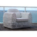 White wicker chair with cushions on a balcony with ocean view