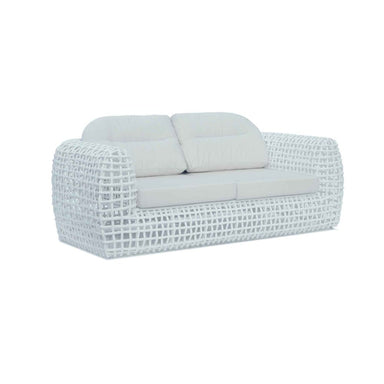 White wicker outdoor sofa with cushions on a white background