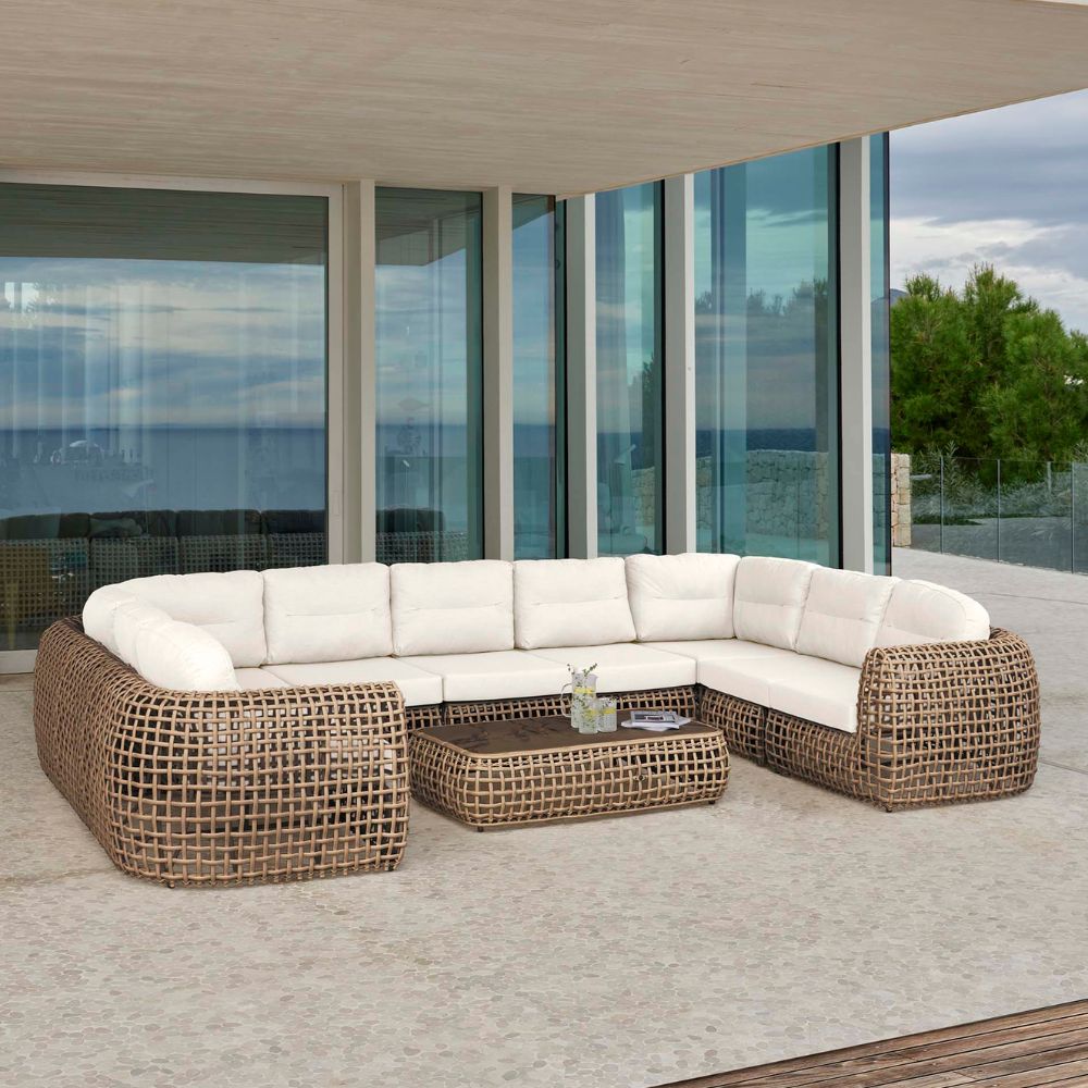 Outdoor patio furniture set with white cushions on a modern deck.