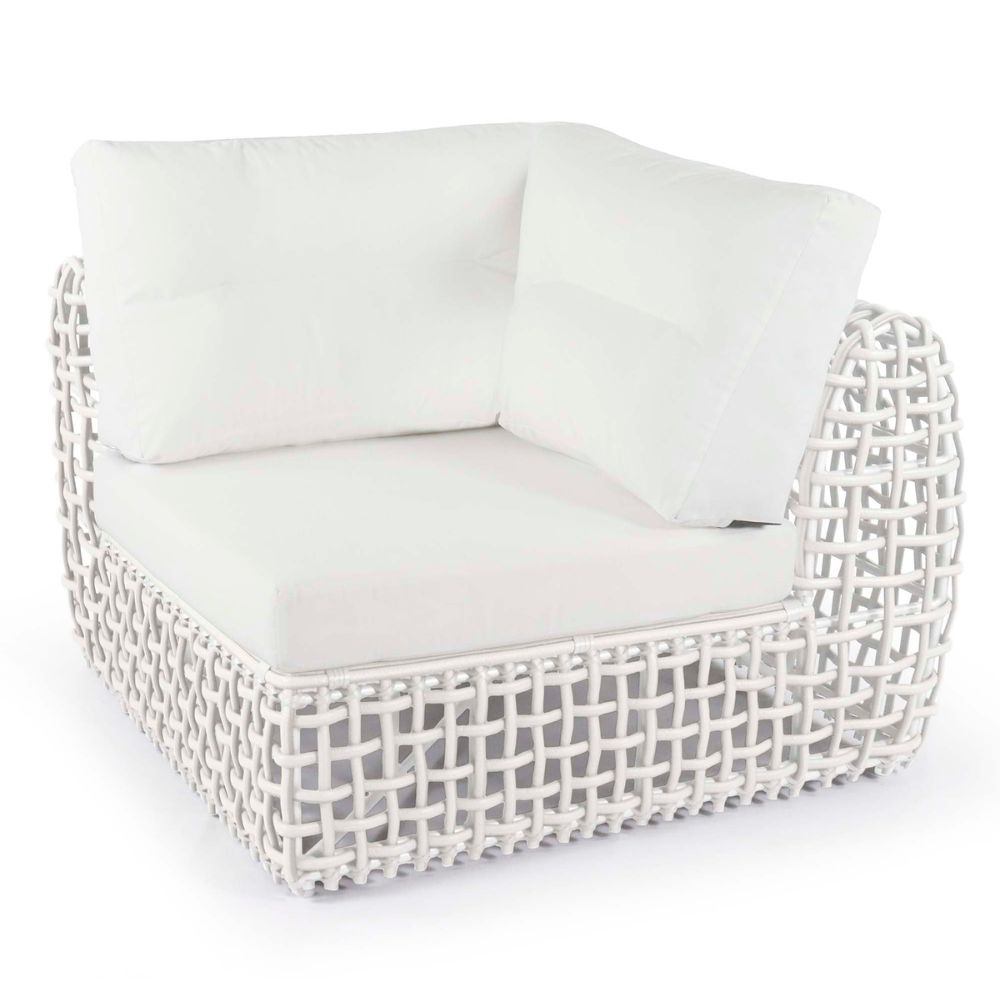 White wicker chair with white cushions on a white background