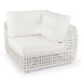 White wicker chair with white cushions on a white background