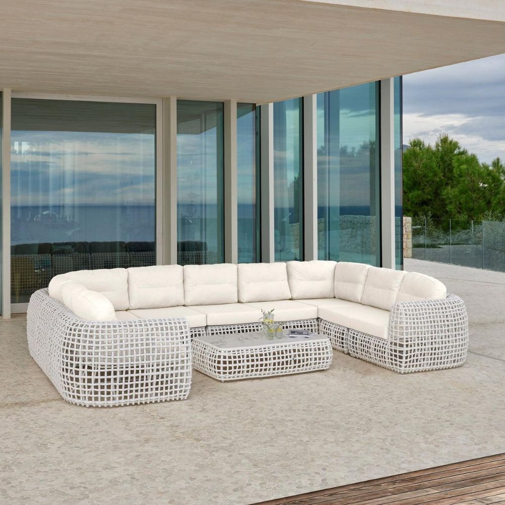 Modern outdoor sectional sofa on a patio with ocean view