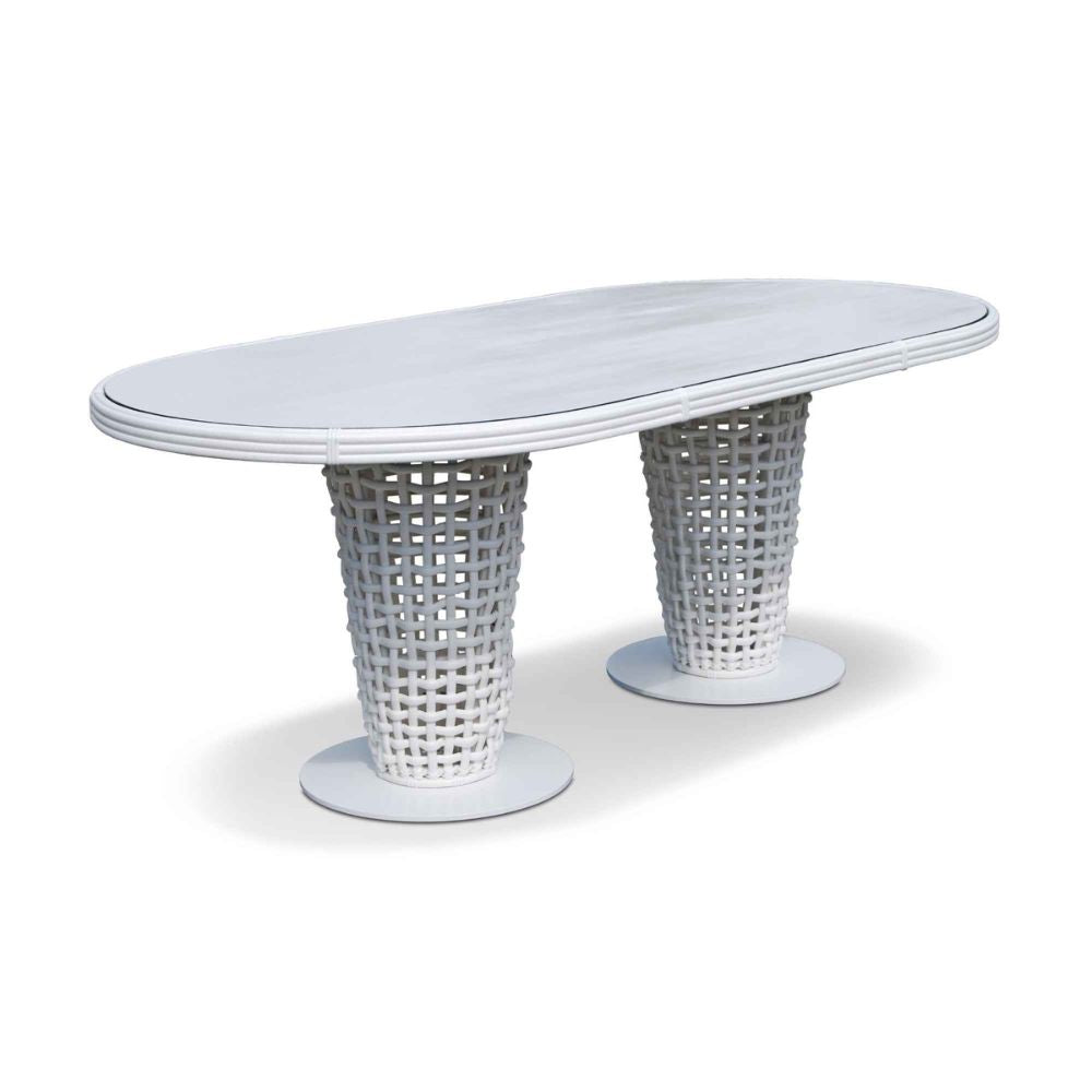 White oval table with wicker base on a white background